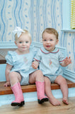 baby boy and girl wearing embroidered cowboy and cowgirl bubble.