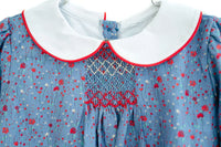 close up of smocking on blue floral outfit