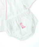 Close up of hand embroidery pink cowgirl boots on baby layette set.