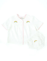 Hand embroidered rainbow layette set.