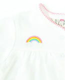 Close up of hand embroidery rainbow on baby layette set.