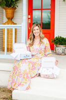 Mom posing with baby gift keepsake boxes blue and pink gingham