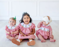 children wearing smocked circus animal outfits