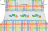 Close up of colorful caterpillars on a fun back to school plaid fabric.