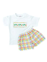 Colorful plaid with cute hand smocked caterpillars on the chest of a boys’ T-shirt and shorts set..