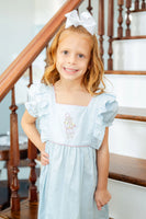 girl wearing embroidered cowgirl dress