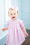 GIRL WEARING SMOCKED PINK GHOSTS DRESS