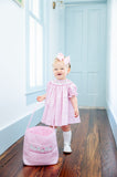 GIRL WEARING SMOCKED PINK GHOSTS DRESS