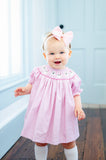 GIRL WEARING SMOCKED PINK GHOSTS DRESS