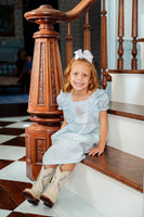 girl wearing embroidered cowgirl dress