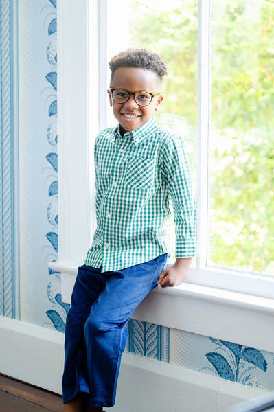 boy wearing green gingham long sleeve button up shirt.