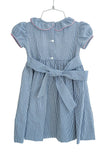 Beautiful navy gingham dress with pink, white and blue hand smocking. Girly ruffle collar and bow on the back!