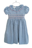 Beautiful navy gingham dress with pink, white and blue hand smocking. Girly ruffle collar and bow on the back!