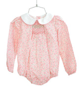 Flat lay of pink floral smocked girl's bubble