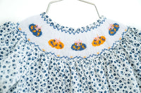 close up on smocked pumpkins on a girl's outfit