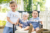 Boy wearing Smocked Hunting T-Shirt and Short Set by Ruth and Ralph with two younger children outdoors