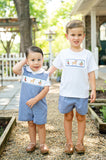 Two boys standing outdoors, one wearing Smocked Hunting Jon Jon by Ruth and Ralph, matching smocked hunting t-shirt