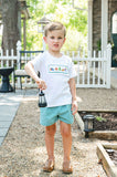Boy standing outdoors wearing Camping Smocked Beau T-Shirt and Shorts Set with green gingham shorts