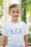 Close-up of boy smiling in Smocked Hunting T-Shirt by Ruth and Ralph, showing smocked deer embroidery detail