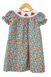 Smocked Floral Pumpkin Dress by Ruth and Ralph, blue floral print with bishop collar, on hanger