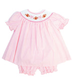 Smocked Pink Football Bloomer Set in pink gingham with a hand-smocked neckline of footballs and bows and coordinating diaper cover