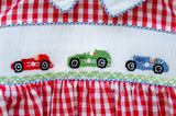 Close-up of smocked race car embroidery detail on Ruth and Ralph red gingham Bubble