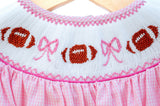 Girl's pink gingham game day bloomer set with a hand-smocked football and bow neckline, a timeless heirloom look