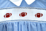 Boy's blue gingham game day bubble featuring a hand-smocked football panel and easy snap closure