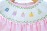 Close-up of smocked rainbow pumpkins embroidery detail on Ruth and Ralph pink gingham Bloomer Set