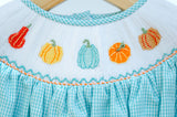 Close-up of smocked fall gourds embroidery detail on Ruth and Ralph teal gingham Bloomer Set, featuring pumpkin and gourd designs
