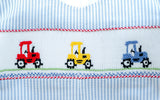 Close-up of smocked tractor embroidery detail on Ruth and Ralph blue striped Bubble