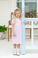 A little girl wearing the Pink Bow Pima Dress looks absolutely adorable in this soft, elegant outfit.