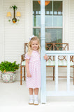 A little girl wearing the Pink Bow Pima Dress feels stylish and cozy all day long, thanks to its breathable fabric.