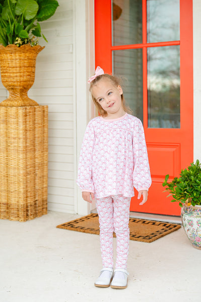 A little girl wearing the Pink Bow Shirt & Leggings Set looks adorable in this comfortable and stylish outfit.