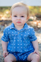 A little boy wearing the Blue Bandana Print Pima Harold Romper looks effortlessly stylish in this charming, western-inspired outfit.