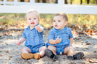 A little boy wearing the blue bandana romper, perfect for both special moments and everyday wear.