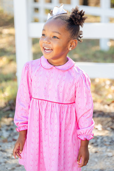 A little girl wearing the Pink Bandana Print Pima Libby Dress looks effortlessly stylish in its soft, playful design.