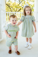 The vibrant plaid of the smocked Mardi Gras short set captures the spirit of Mardi Gras, making it a standout choice.