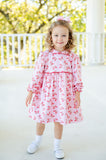 A little girl in the Butterfly Heart Dress, her outfit full of playful butterflies and sweet details.