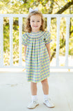 Perfect for parades, the smocked dress combines playful plaid and elegant details to celebrate the season in style.