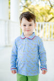 A little boy wearing the Lovely Caterpillars Shep Polo Long Sleeve Shirt looks absolutely adorable in this playful design featuring all-over caterpillars and hearts on a soft blue background.