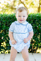 A baby boy looks adorable in the Blue Heart Pima Bubble, featuring a soft blue plaid pattern with heart accents.