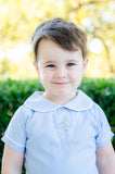 A little boy’s excitement shines as he proudly wears the Stork Embroidered Big Brother Peter Pan Collar Shirt, a timeless piece that celebrates his new role.