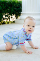 The caterpillar heart pattern, with its whimsical design, adds a charming touch to the romper’s classic blue hue.