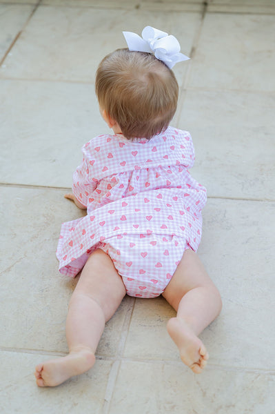 A baby wearing the Pink Hearts Layette Set looks incredibly sweet in this soft, pima cotton outfit adorned with adorable heart accents.