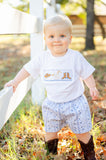 A little boy wearing the Boots and Bandanas Smocked Shirt and Shorts Set looks charming in this playful, western-inspired outfit.