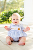 A little baby boy wearing the smocked Bandana and Boots Rodeo Henry Bubble in blue looks absolutely adorable in this western-inspired outfit.