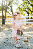 A little girl wearing the Smocked Cowgirl Toile Helen Dress is sure to stand out at any family gathering or special event with its sweet yet rustic style.