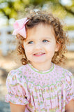 A little girl wearing the Smocked Cowgirl Toile Annabelle Bloomer Set looks absolutely charming in this western-inspired outfit.