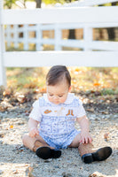 A little boy sitting in the Bandana and Boots Rodeo Benjamin Jonjon enjoys the soft, breathable fabric, perfect for all-day comfort.